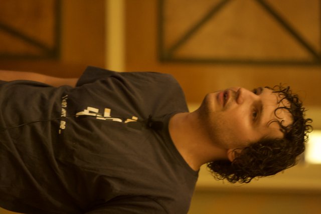 Curly-Haired Man in Black T-Shirt