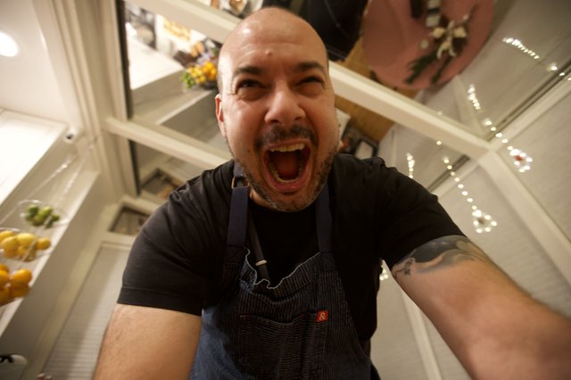 Exuberant Chef Takes Selfie in Modern Kitchen