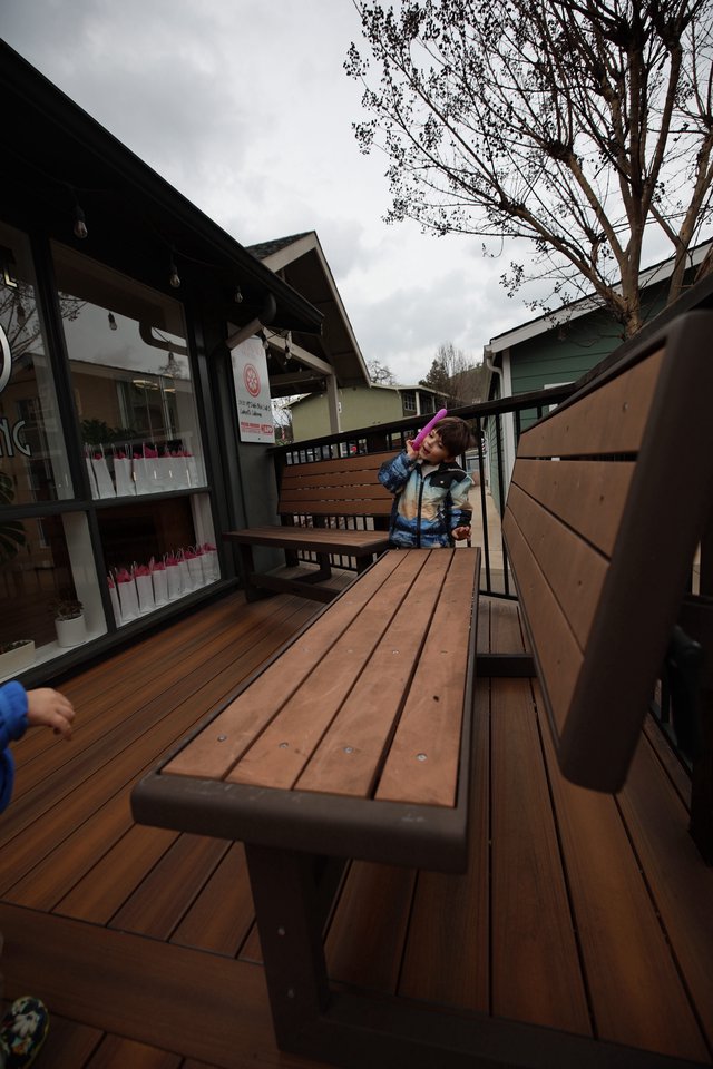 Child on Outdoor Restaurant Deck on Cloudy Day