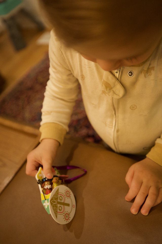 Young Child Playing with Christmas Ornament Toy
