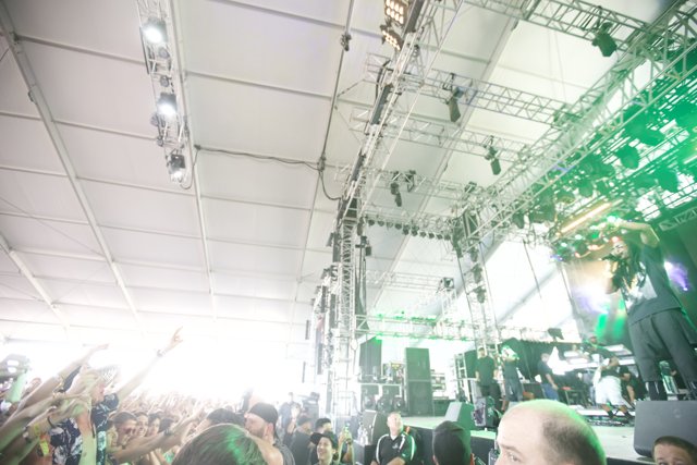 Green Spotlight Shines on Concert Crowd