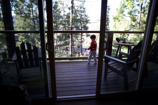 Child Playing on Mountain Cabin Deck at Dusk