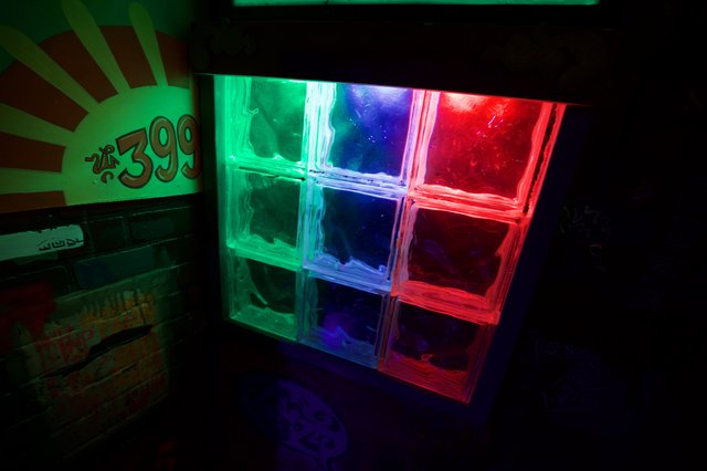Illuminated Glass Block Wall with Retro Neon Design