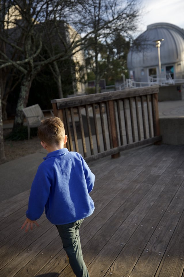 Young Boy Exploring Wooden Deck at Observatory