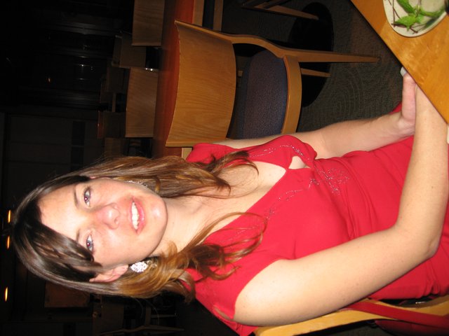 Woman in Red Dress at Restaurant Dinner Table