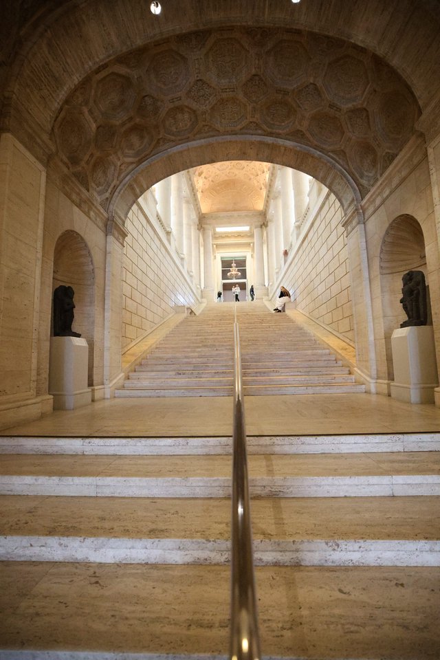 Grand Neoclassical Staircase Under Ornate Coffered Arch