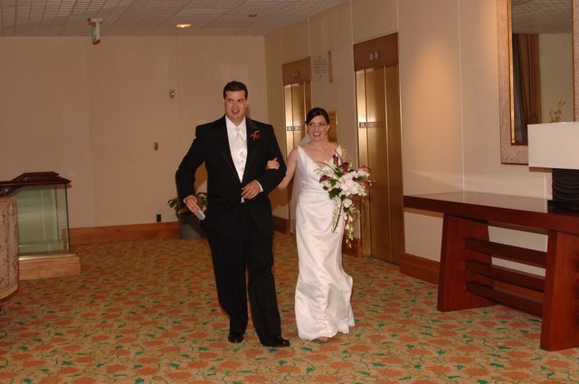 Newlyweds Walk Arm in Arm Through Hotel Lobby