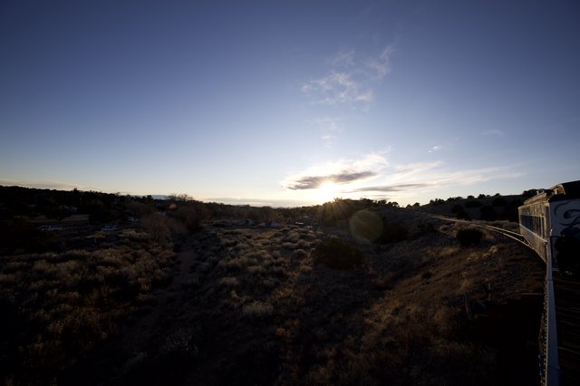 Sunset Over Desert Landscape with Train Car