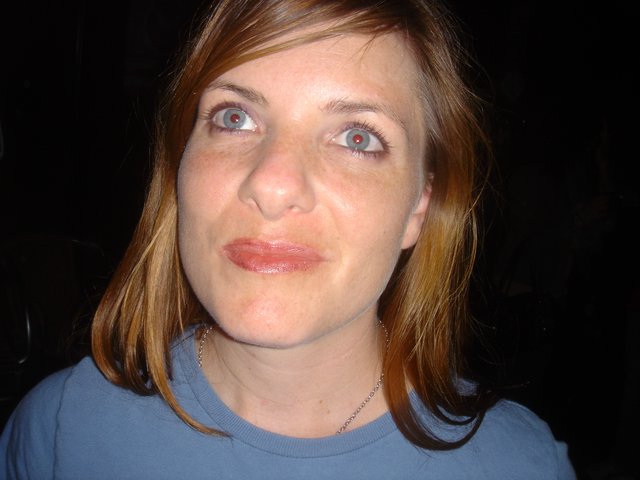 Woman with Red-Eye Effect Looks Upward Quizzically