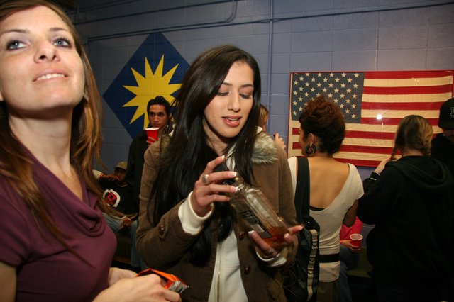 Two Women at an Indoor Party with Flags
