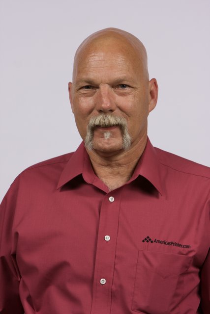 The Red Shirted Bald Man with a Mustache