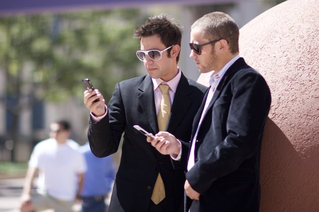 Businessmen checking their phones