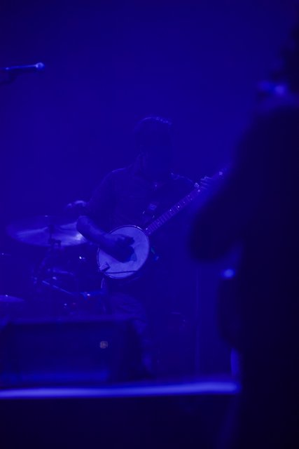 Man playing banjo on stage during Coachella concert