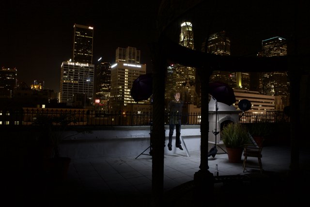 Urban Night Skyline with Chair and Decorative Plant