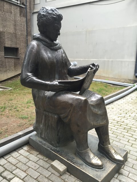 Statue of a Woman Enjoying a Good Read