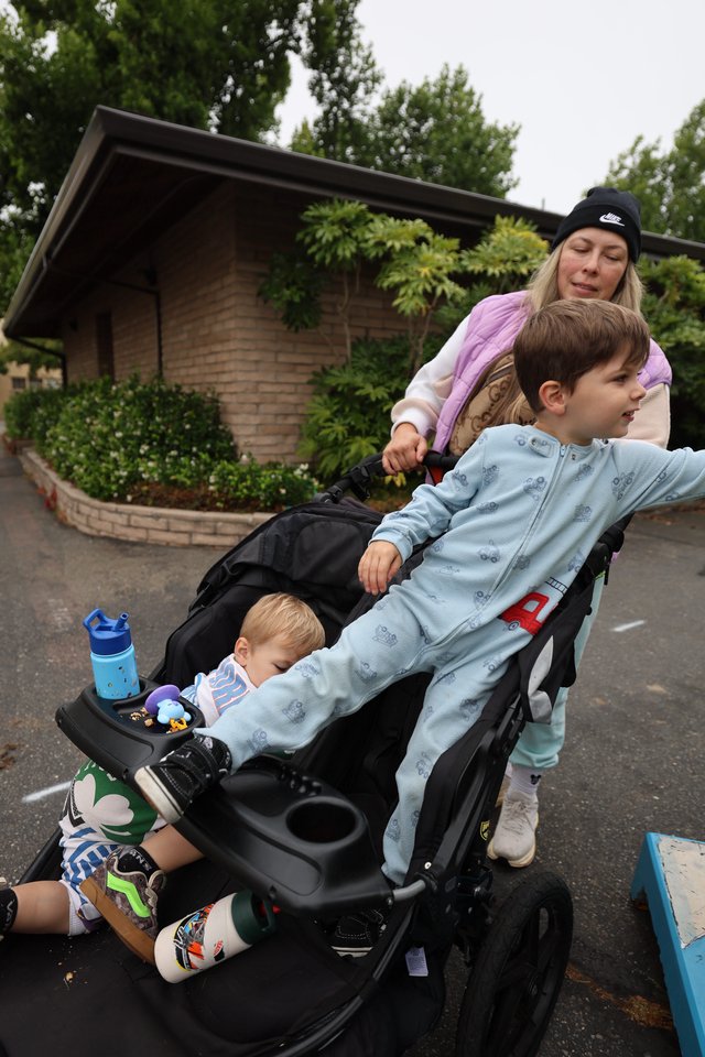 Mom Pushes Two Kids in Stroller at Balloon Festival