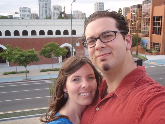 Couple Selfie on Urban Rooftop Overlooking City Street