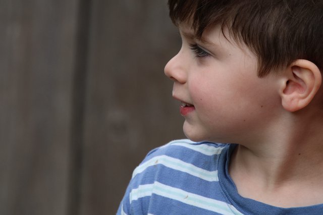 Young Boy's Profile in Blue Striped Shirt