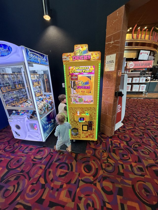 Children Playing Arcade Games at Movie Theater Lobby