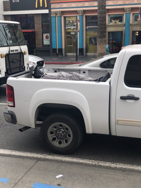 White Pickup Truck in Front of Storefront