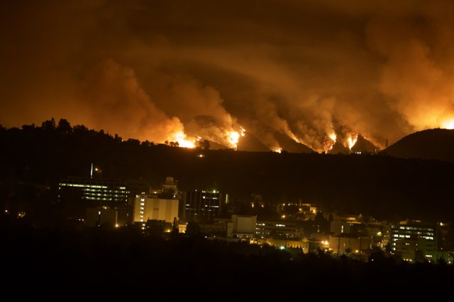 Flames Engulfing the Hills Above the City