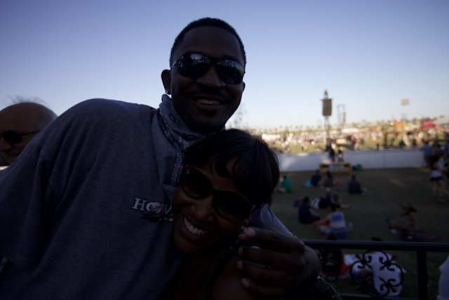 Smiling Duo Poses in Front of Stage at Coachella