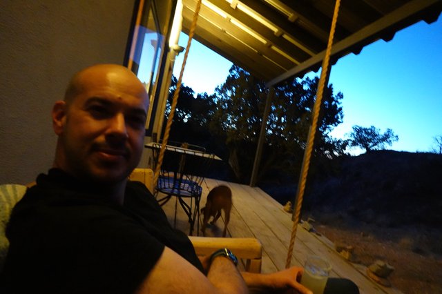 Bald Man Enjoying Evening on Covered Porch