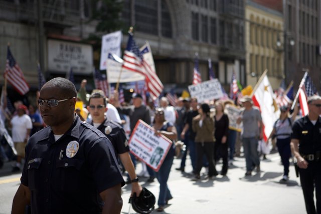 Police Officer Joins Protestors at Black Minutemen Parade