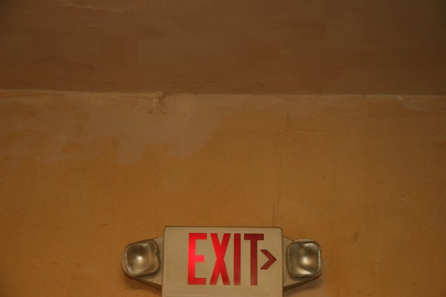 Red Exit Sign on Wood Wall