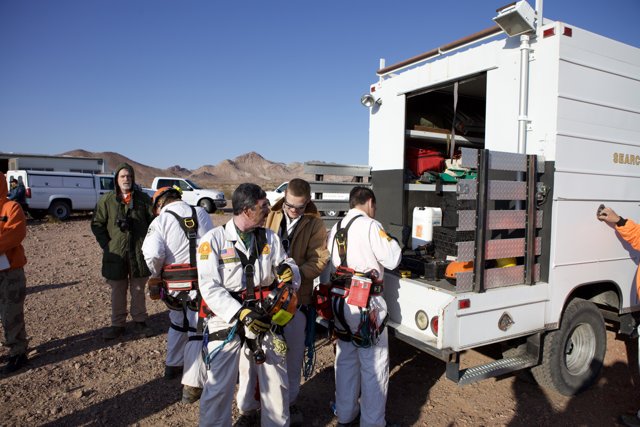 Mine Rescue Team Gathers Around White Truck