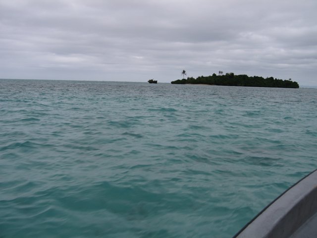 A Boat Anchored Near the Island