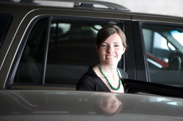 Smiling Woman Beside a Dark SUV Door