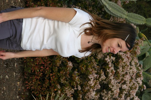 Smiling Woman in White Tee Among Desert Blooms