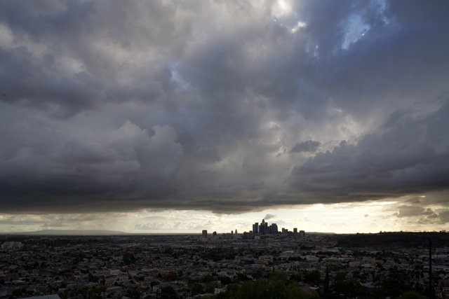 Cityscape under a dramatic, cloudy sky