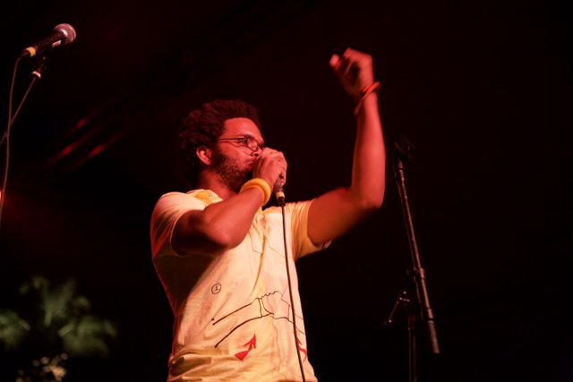 Yellow-Shirted Entertainer with Microphone