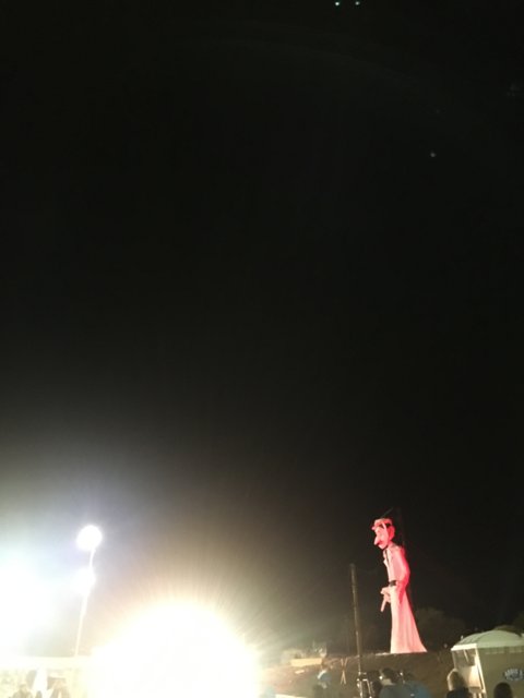 Red Statue Illuminated by Night Sky