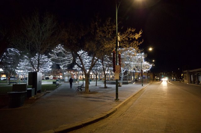 Festive Holiday Lights Illuminate Empty Town Square at Night