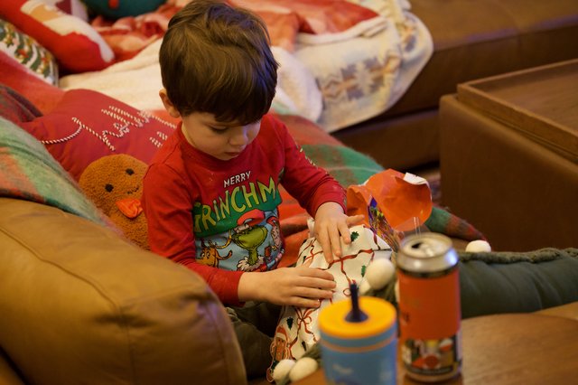 Christmas Morning Joy: Child Opening Holiday Gifts