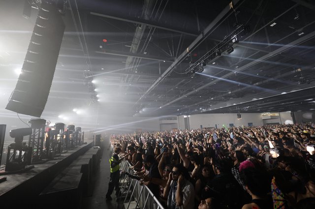Massive Indoor EDM Crowd Bathed in Stage Light