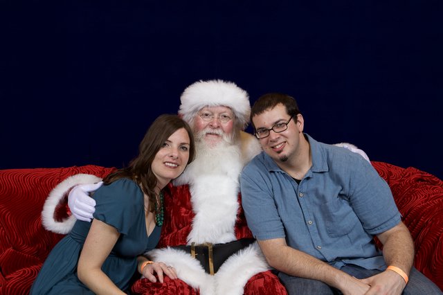 Couple Poses with Santa at Christmas Party