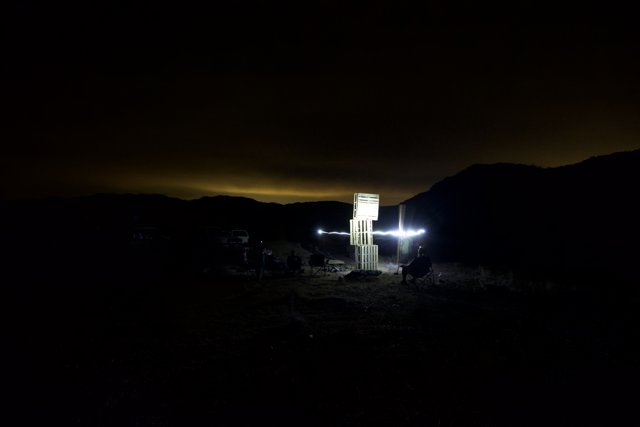 Illuminated Cross in the Dark Desert Night