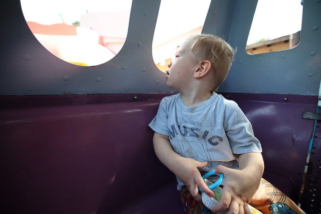Young Boy Gazing Upward in Playground Structure