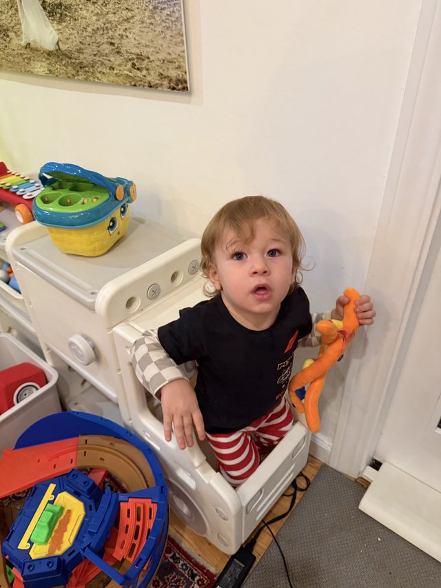 Toddler Playing with Toys in Learning Tower