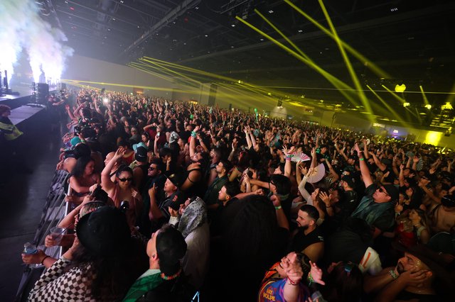 Massive Indoor EDM Festival Crowd Under Laser Light Show