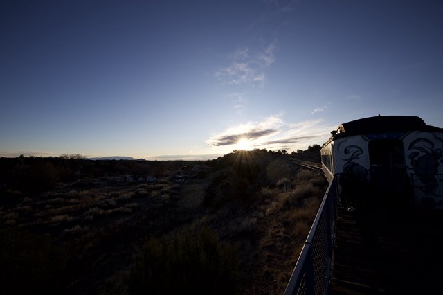Sunset Over Railroad Tracks with Decorated Building