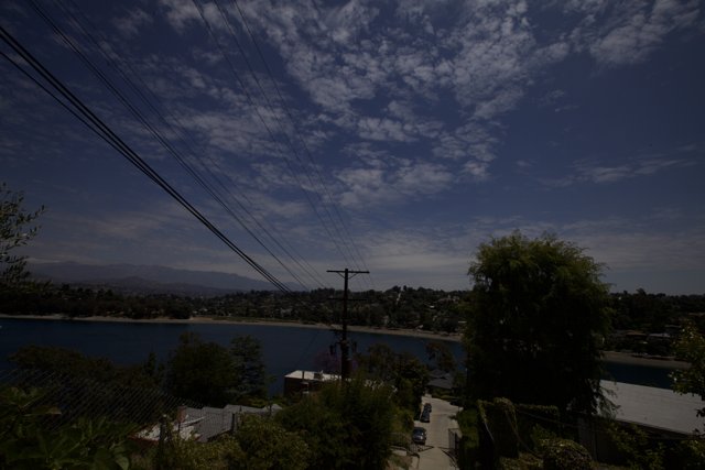 A Scenic View of Power Lines and Sky from the Hillside