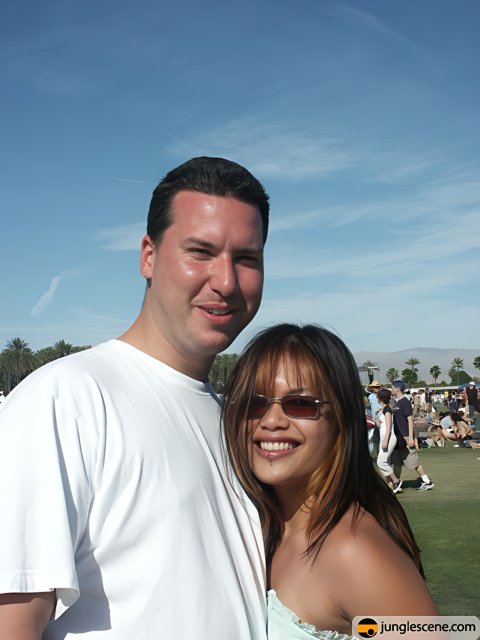 Posed portrait of Rob G and a woman at Coachella