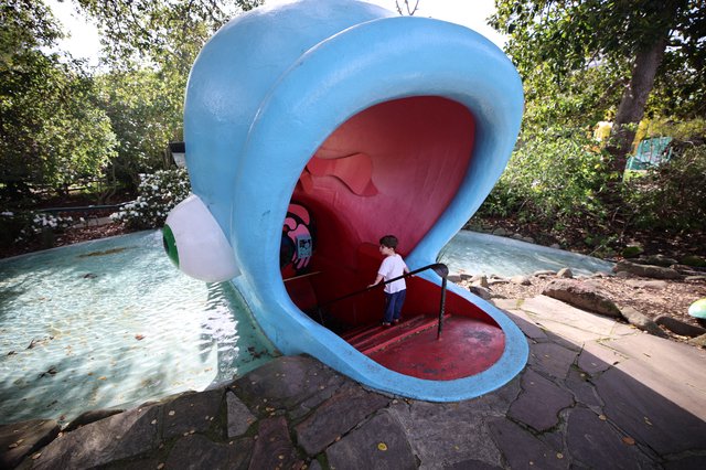 Child Exploring Giant Whale Mouth Playground Sculpture