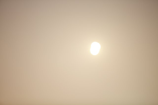 Sun's Illumination Over a Foggy Landscape