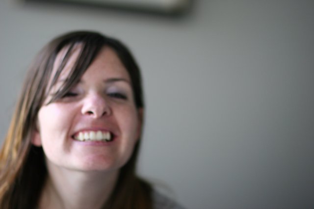 Laughing Young Woman with Eyes Closed in Joy